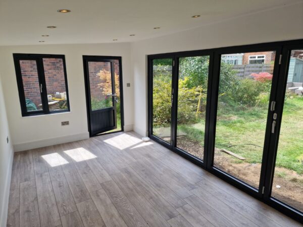 Inside 9ft x 17ft Plastic Ampleforth Garden Room with Bi-fold doors